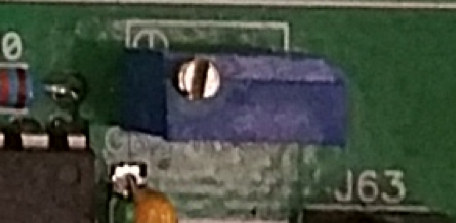 Electronic circuit board with adjustable potentiometer for precise voltage regulation, close-up view.