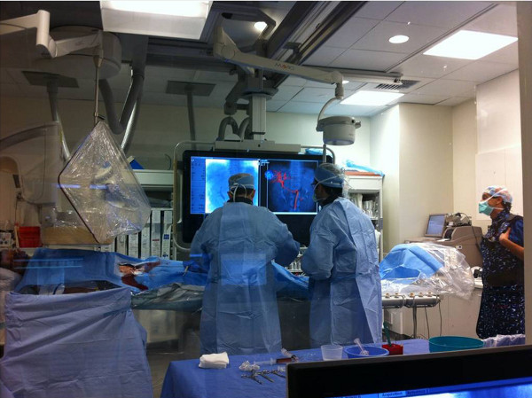 figure-results-1 Surgical procedure with angiography diagram, monitoring equipment, and medical staff in operating room.