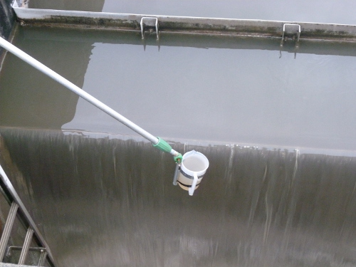 figure-results-9 Water sampling process; bucket sampler collecting samples from wastewater treatment flow.