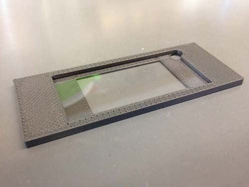 figure-results-3 Microscope slide holder, black frame, used for stabilization in microscopy experiments.