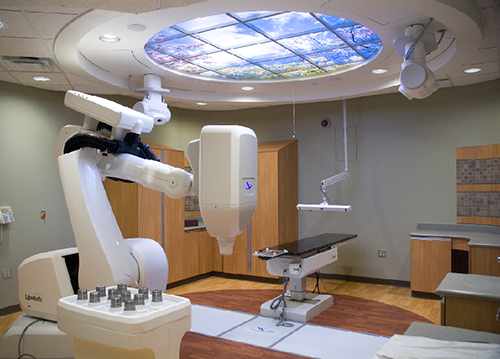 Robotic radiotherapy system in a medical facility, showing treatment setup for precise cancer therapy.
