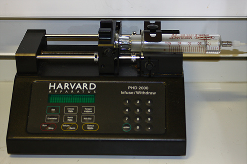 figure-results-3 Syringe pump setup for fluid infusion experiment; Harvard Apparatus PHD 2000; research equipment.