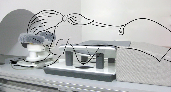 CT scan setup; illustrated guide overlay; medical imaging procedure equipment.