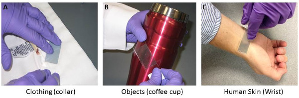 Tape lift technique on fabrics, objects, skin; adhesive transfer study; sample collection method.
