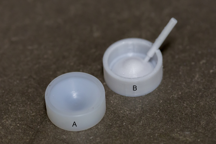 Lab setup with split cast molds labeled A and B, dental impression material preparation.