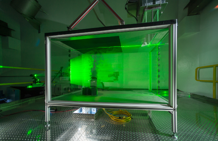 figure-results-2 Laser optics lab setup with green laser for fluid dynamics study, optical measurement apparatus.