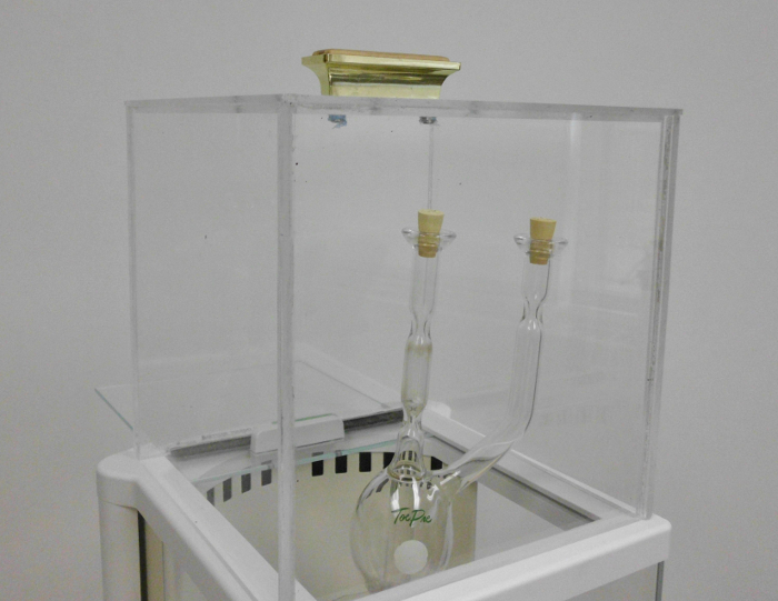 Vacuum distillation setup, glass apparatus in a transparent chamber for separation under reduced pressure.