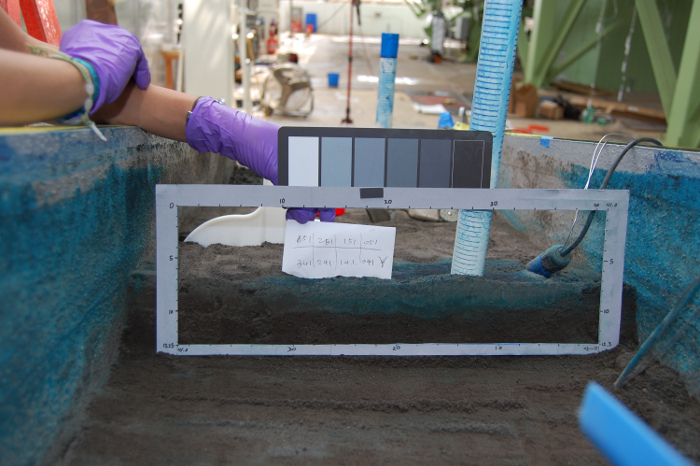 Sediment layer analysis using color chart, experimental setup for soil composition study.