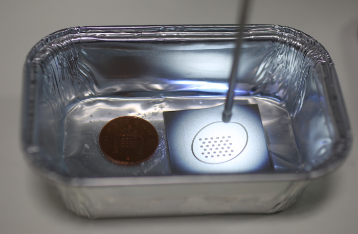 figure-results-2 Electroplating experiment setup, ion deposition process, coin and metal substrate in solution tray.