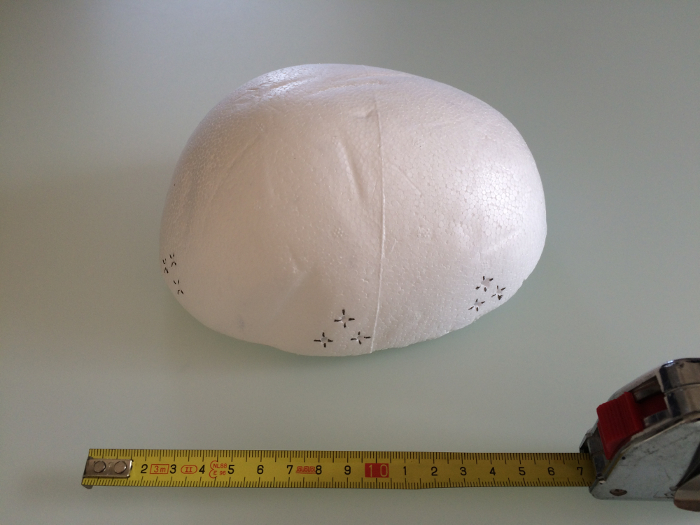 White dome structure with measurement tape, DIY model size estimation.