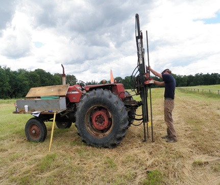 Soil sampling process using auger mounted on a tractor; field analysis preparation.