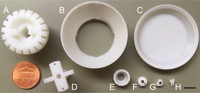 Microcentrifuge component diagram, labeled parts A-H with coin scale, highlighting assembly details.