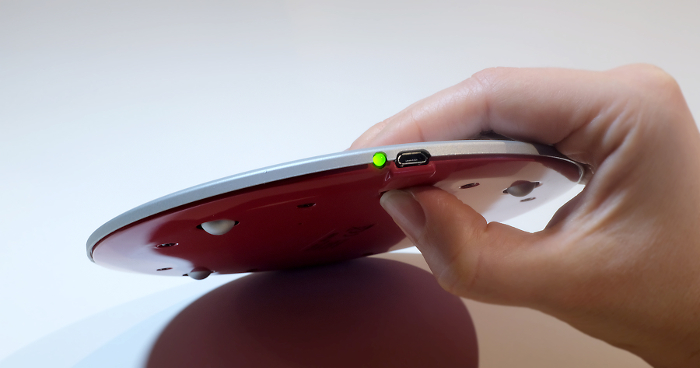 Wireless charger with USB-C port and LED indicator, showing power connectivity setup.
