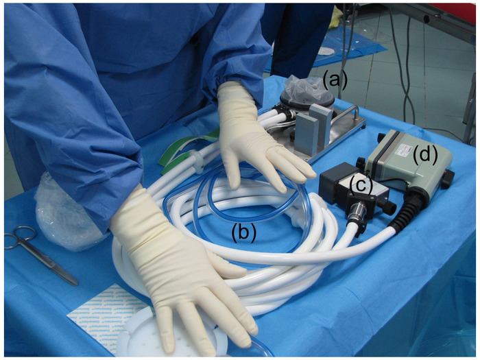 figure-results-1 Surgical setup with tubing and instruments for medical procedures; gloves indicate sterile conditions.