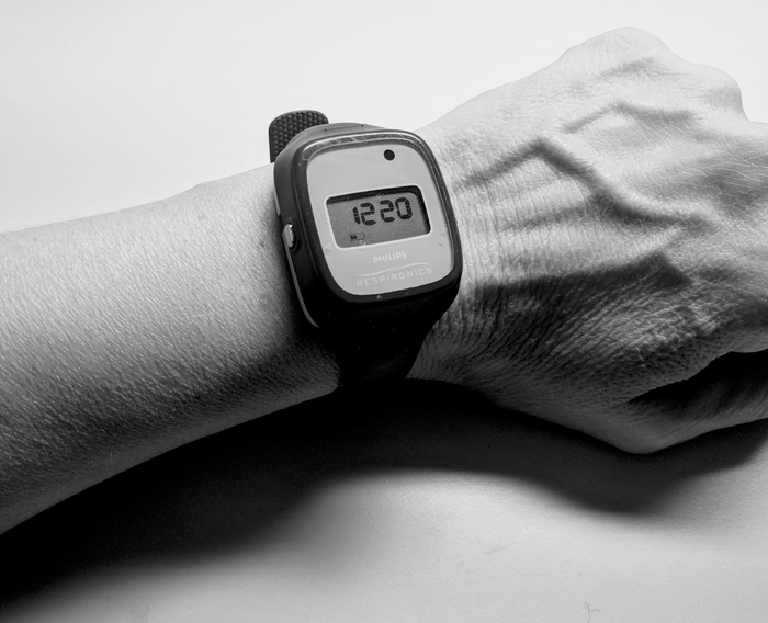 Digital watch displaying time on wrist, emphasizing wearable technology and timekeeping.