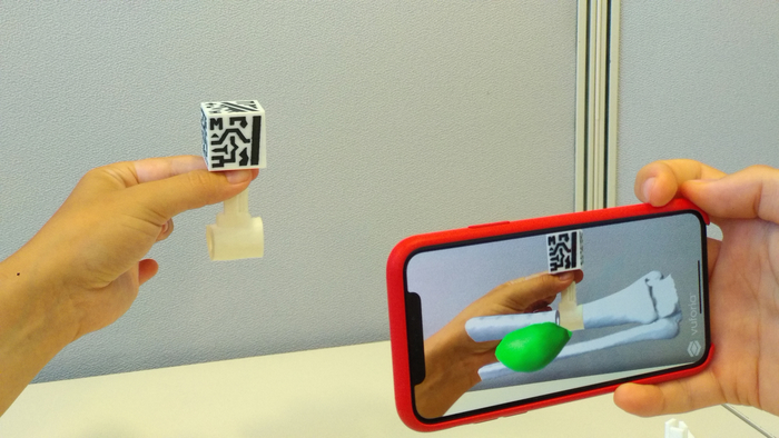 figure-results-7 Augmented reality demo using QR code for virtual object interaction, educational technology application.