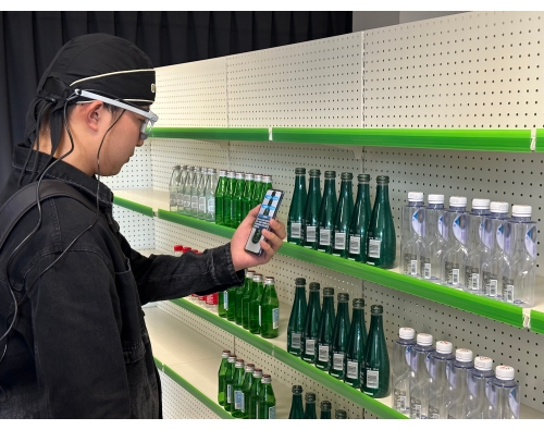 Augmented reality application testing, user analyzes product information on mobile while in a store aisle.