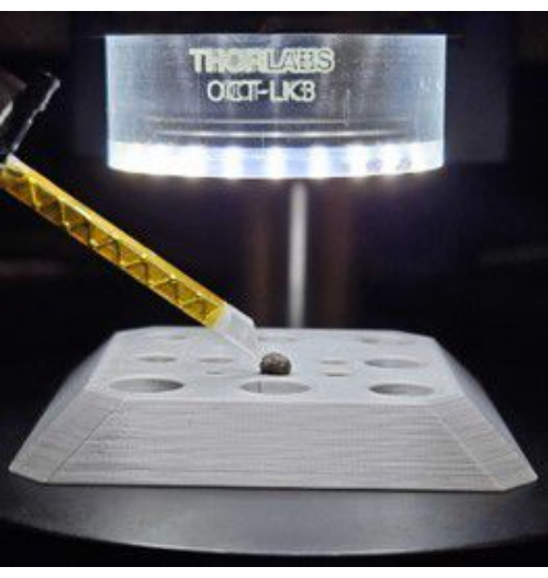 Spectroscopy setup with LED ring light and sample holder for optical excitation analysis.