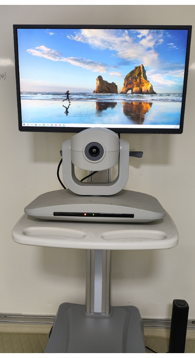 Teleconferencing setup with camera and display for remote visual communication and collaboration.