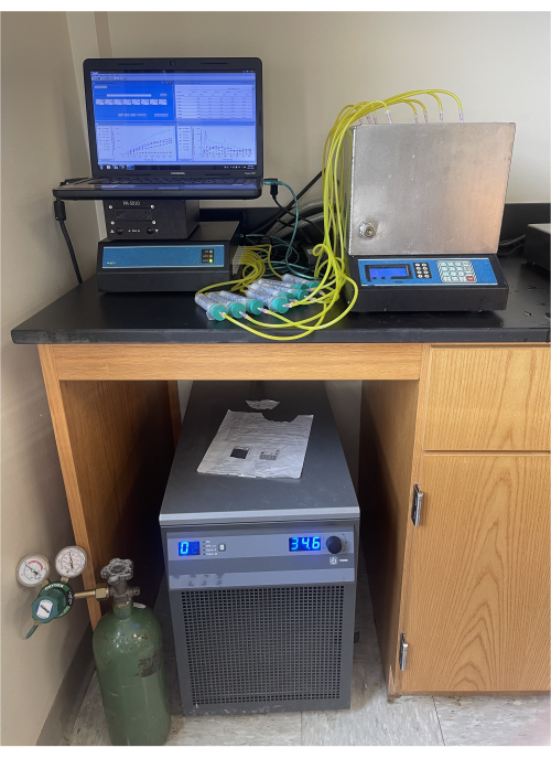 PCR workstation setup for DNA amplification, featuring thermal cycler and data analysis display.