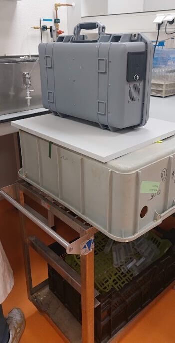 Laboratory setup with portable spectroscopy equipment on bench for chemical analysis.