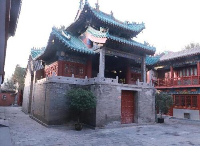 Traditional Chinese architecture with ornate roofs and red wooden structures.