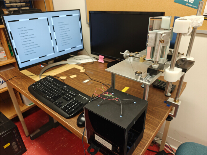 Spectroscopy setup with computer; optical measurement analysis equipment and data display.