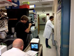 A professional videographer films in the laboratory.