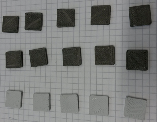 figure-results-7 3D printing material comparison on grid paper; analysis of texture and color differences in samples.
